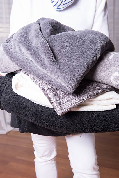 istock female helper welcomes refugees with warm blankets for cold nights 490877674