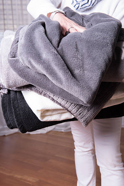 istock female helper welcomes refugees with warm blankets for cold nights 490877974
