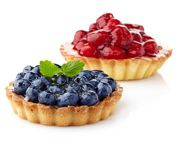 Blueberry and raspberry tarts Two berry tarts isolated on white background tart dessert stock pictures, royalty-free photos & images