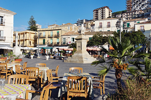 Pizzo,Calabria,Italy - September 23, 2013: View over  the Piazza della Republica , the main square in Pizzo. The city is very famous for its tartufo ice cream. At the plaza you can find many ice cream parlors and outdoor bars. Some tourists are walking on the square. 