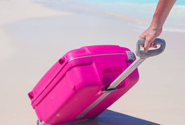 istock Young traveler with his luggage on a tropical beach 490879943