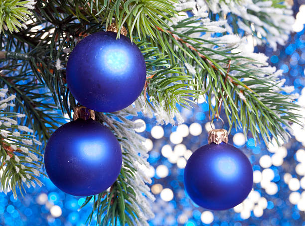 istock Dark blue New Year's balls on a snow-covered branch 490880582