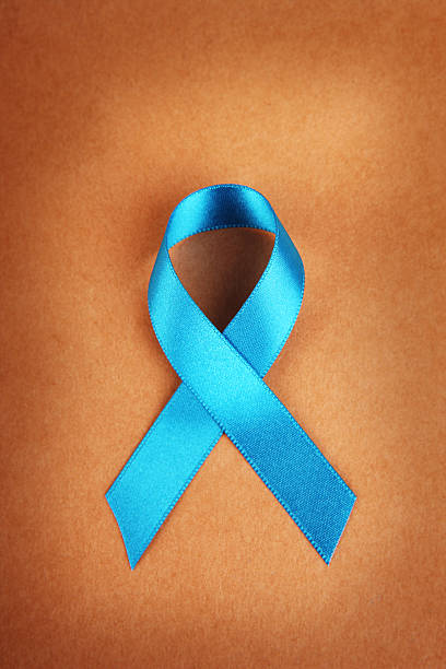 Teal Awareness Ribbon on Brown Teal awareness ribbon on brown paper background polycystic ovary syndrome photos stock pictures, royalty-free photos & images