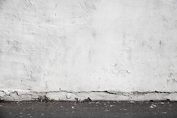 istock White wall and asphalt pavement. Urban interior background 490880705