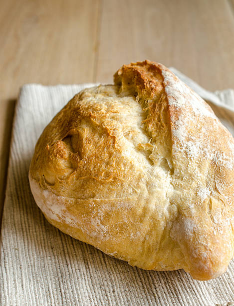 istock Loaf of white bread on the wooden table 490881069