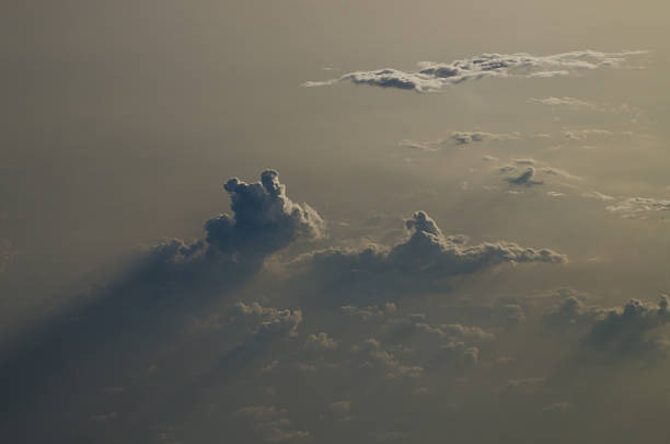 Clouds from the air with rays of sunlight stock photo