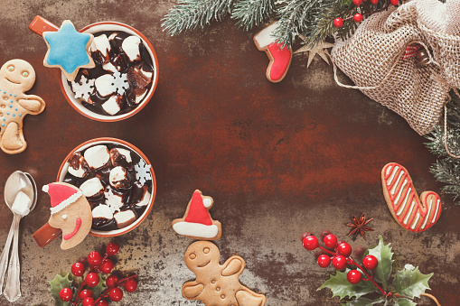 Hot chocolate with marshmallow and gingerbread cookies. Christmas decorations. Vintage style with blank space, top view