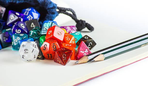 istock Dice spilling out of a Dice bag with Pencils 490882766