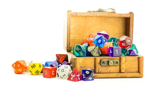 A small wooden chest overflows with multicolored dice