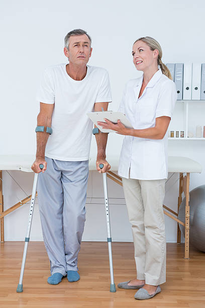 istock Man with crutch speaking with to doctor 490883710