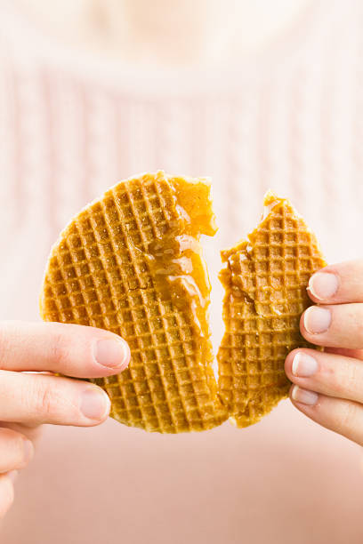 istock Woman tearing a dutch syrup waffle 490884861