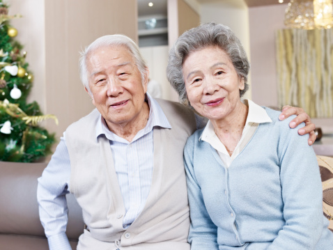 home portrait of senior asian couple smiling.