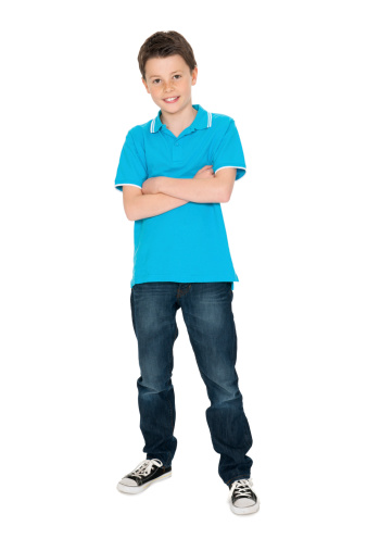 Full length portrait of confident boy standing arms crossed over white background
