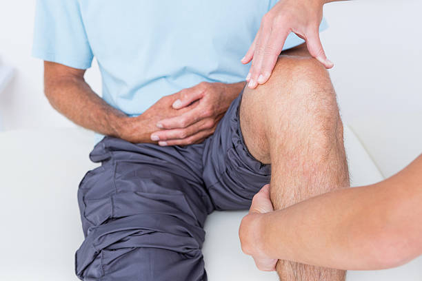 istock Doctor examining her patient knee 490886216
