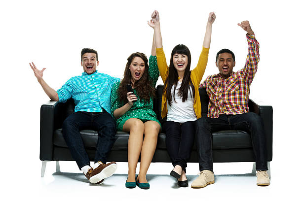 istock Cheerful four people sitting on couch and cheering 490886569