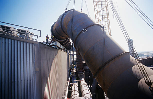 istock Installing fume extraction pipe into steel foundry smelter 490886713
