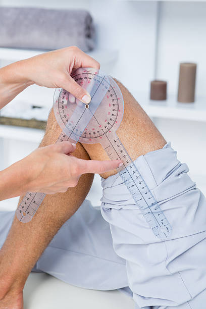 istock Doctor examining man leg with tool 490888444