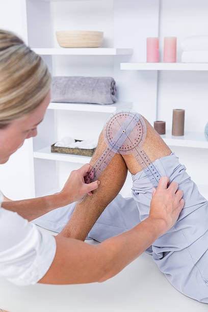 istock Doctor examining man leg with tool 490888480