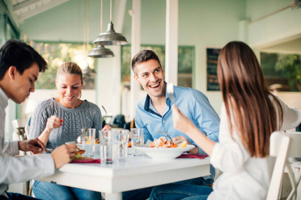 istock Friends Enjoying Lunch In Restaurant. 490890652