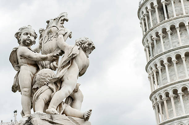 istock Angels Statue and Leaning Tower of Pisa, Italy. 490890694