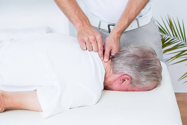 istock Physiotherapist doing neck massage to his patient 490891196