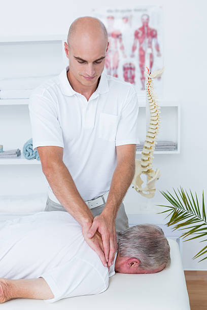istock Physiotherapist doing neck massage to his patient 490891370