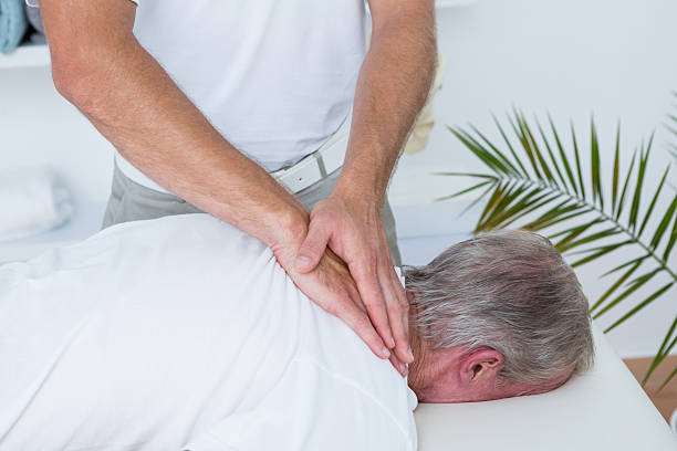 istock Physiotherapist doing neck massage to his patient 490891438