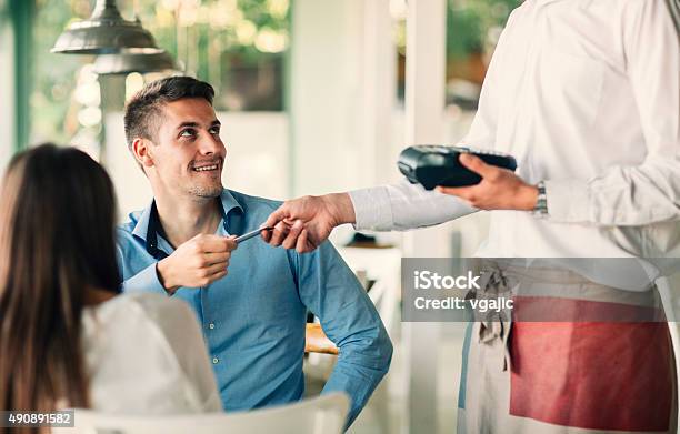 Man Paying Their Lunch With Credit Card In Restaurant Stock Photo - Download Image Now