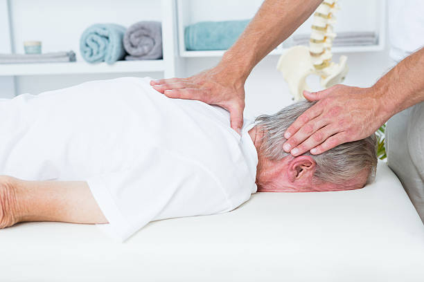 istock Physiotherapist doing neck massage to his patient 490908138