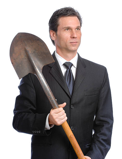 istock Businessman Holding Shovel on White 490908286