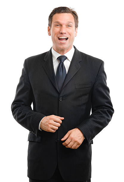 Confident senior businessman in a formal dark suit, standing professional pose with one hand on his jacket and the other in his pocket, isolated on white background, symbolizing leadership, success