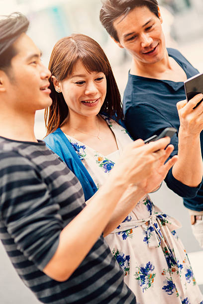 istock Happy japanese friends surfing the net 490913874
