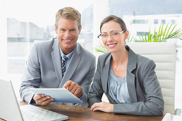 istock Smiling business partners working together 490914036