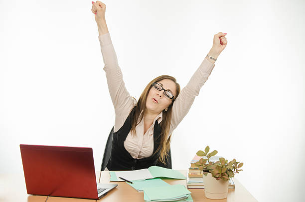 Teacher stretches sitting at your desk Cute little girl is a teacher sitting at a desk with a laptop, books and notebooks Highest Paying Freelance Jobs stock pictures, royalty-free photos & images