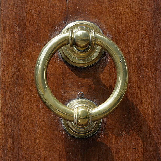 istock Dark wooden door with old bronze handle 490916220