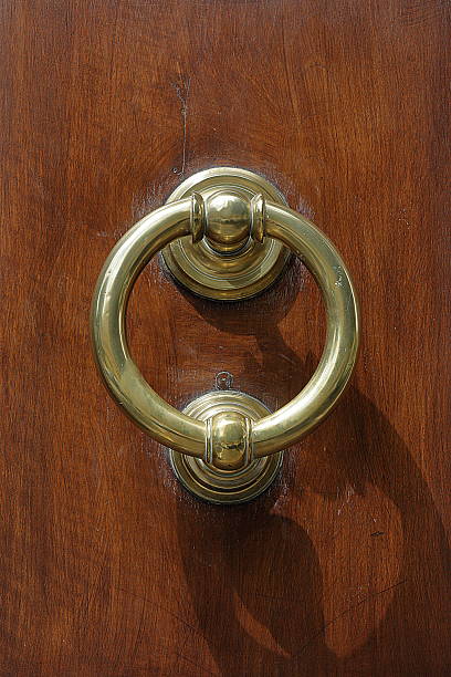 istock Dark wooden door with old bronze handle 490916392