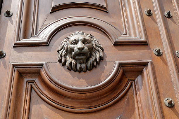 istock The muzzle of lion on old wooden door 490916530