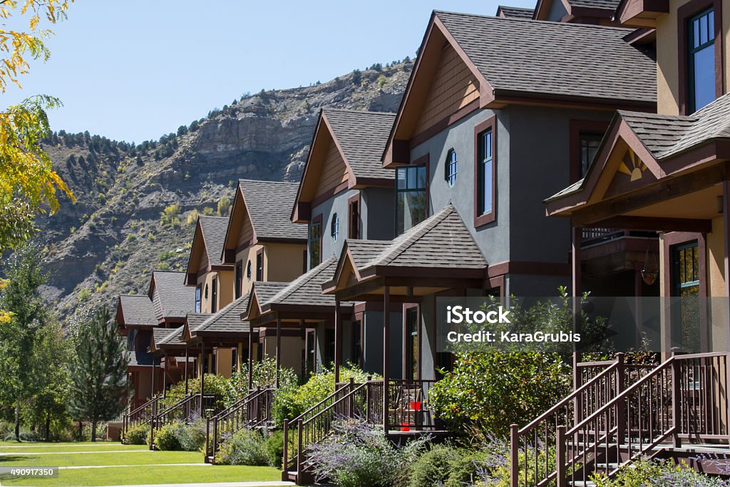 Row of condominiums in downtown Durango, Colorado Image of the front porches on a row of condominiums in historic downtown Durango, Colorado.  Behind the homes, the cliff of Smelter mountain can be seem.  The many repeating identical homes are typical row homes. Colorado Stock Photo