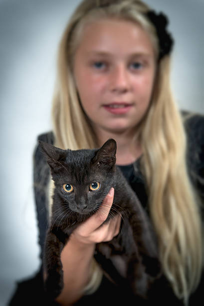 istock Blond girl and black cat 490917422