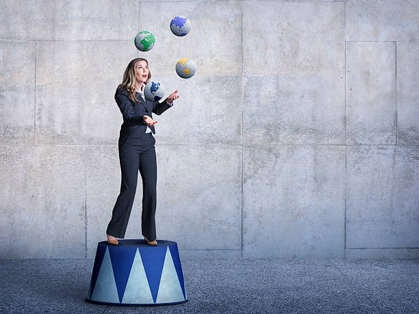 istock Businessman Standing On Pedestal Juggling Several Globes 490922512