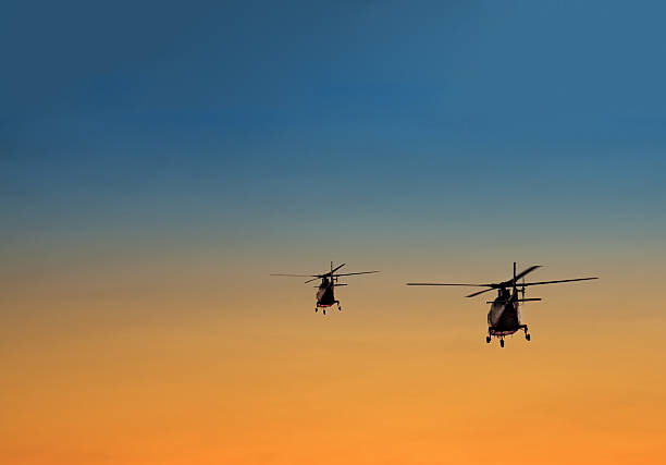 istock silhouette of two helicopters 490923975