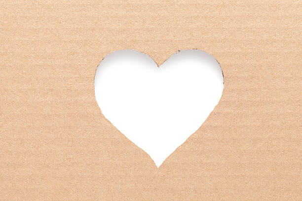 Cardboard heart Heart cut in cardboard. This file is cleaned, retouched and contains  book heart shape valentines day copy space stock pictures, royalty-free photos & images