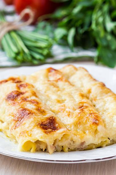 istock Italian pasta Cannelloni stuffed with meat, white Bechamel sauce 490926095