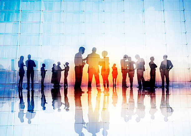 Silhouettes of Business People Discussing Outdoors Silhouettes of Business People Discussing Outdoors silhouette people group stock pictures, royalty-free photos & images