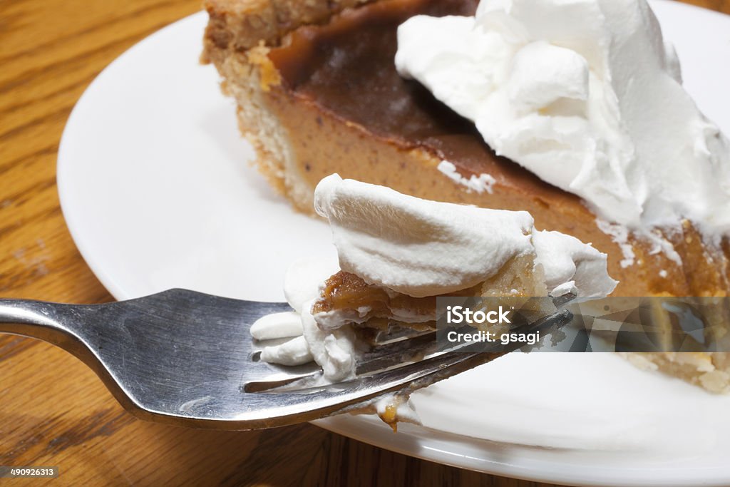 Fork full Silver folk that is full of sweet potato pie and whipped creme Sweet Potato Pie Stock Photo