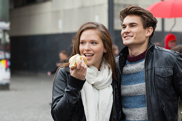 istock Couple With Hot Dog Looking Away 490928733