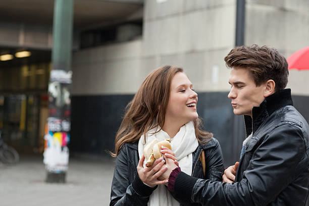 istock Couple In Jackets Holding Hot Dog 490928737