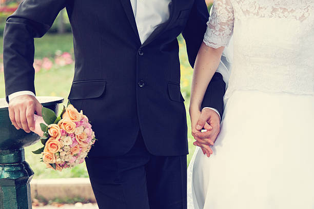 istock Wedding couple holding hands 490928967