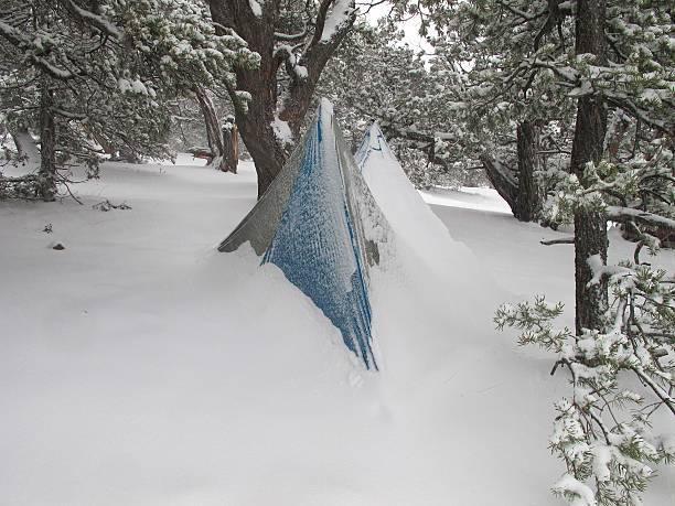 Ultralight Snow Camping Snow blankets an ultralight tent after a storm in Mosca, CO, outside the Great Sand Dunes National Park and Preserve ultralight stock pictures, royalty-free photos & images