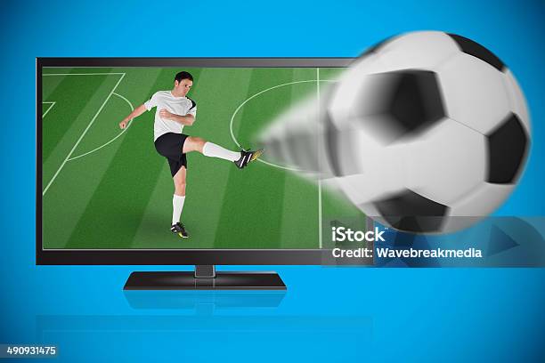 Football Player In White Kicking Ball Out Of Tv Stock Photo - Download Image Now - 30-34 Years, 30-39 Years, Activity